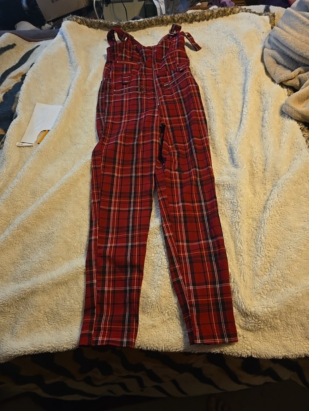 070226 This is a plaid jumpsuit, similar to styles offered by brands like an Ang
